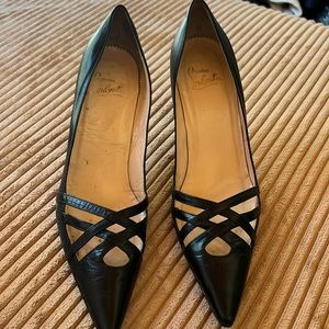 Black Louboutin. Leather crossed heals